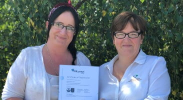 grotech staff holding the latest ISO certificate