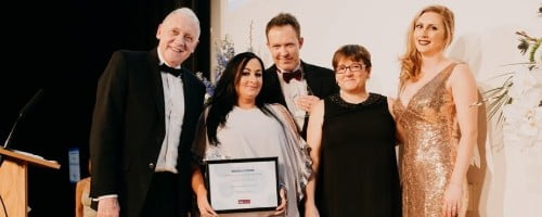 members of grotech staff receiving business award at event dinner