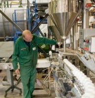 member of grotech staff inspecting bottles on filling line