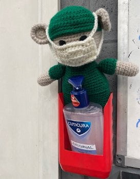 fred standing over a hand sanitiser dispenser