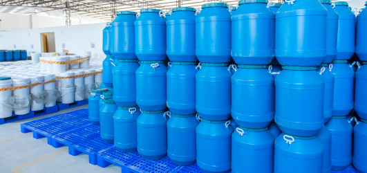 blue plastic barrels in factory