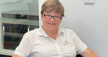 office manager tracey sitting on office chair