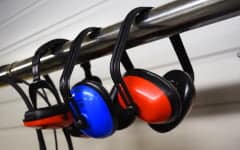 safety ear defenders hanging on a rail