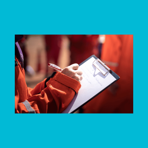 Risk person wearing high viz jacket whilst writing on clipboard on teal background