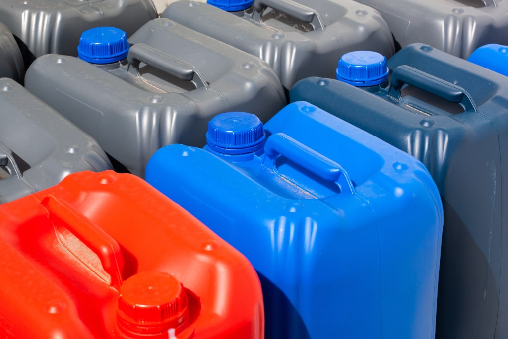 close up of different coloured jerrycans