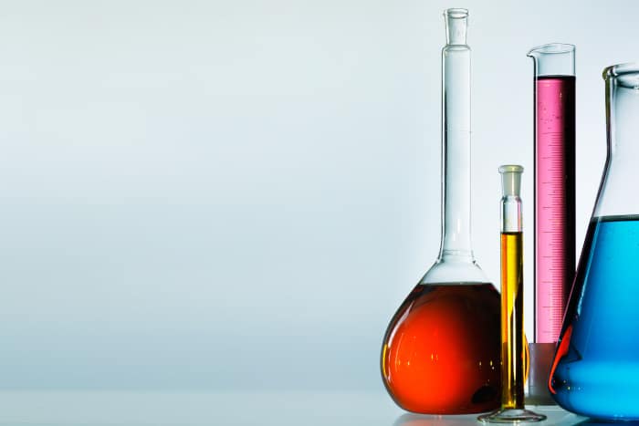 laboratory glassware filled with different coloured liquids