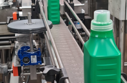 filling-packing green bottles going down a production line
